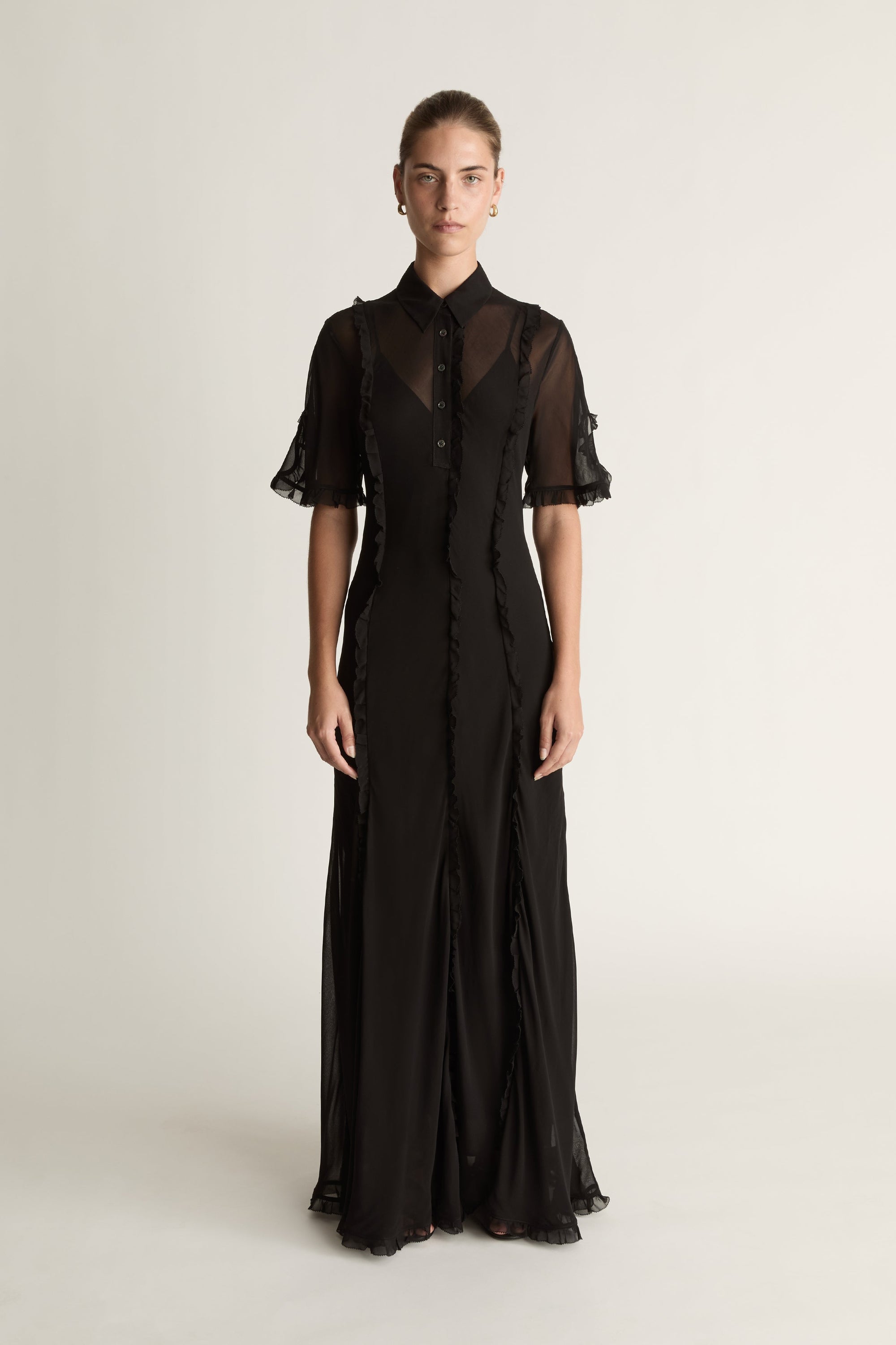 Black dress with sheer sleeves on a white background