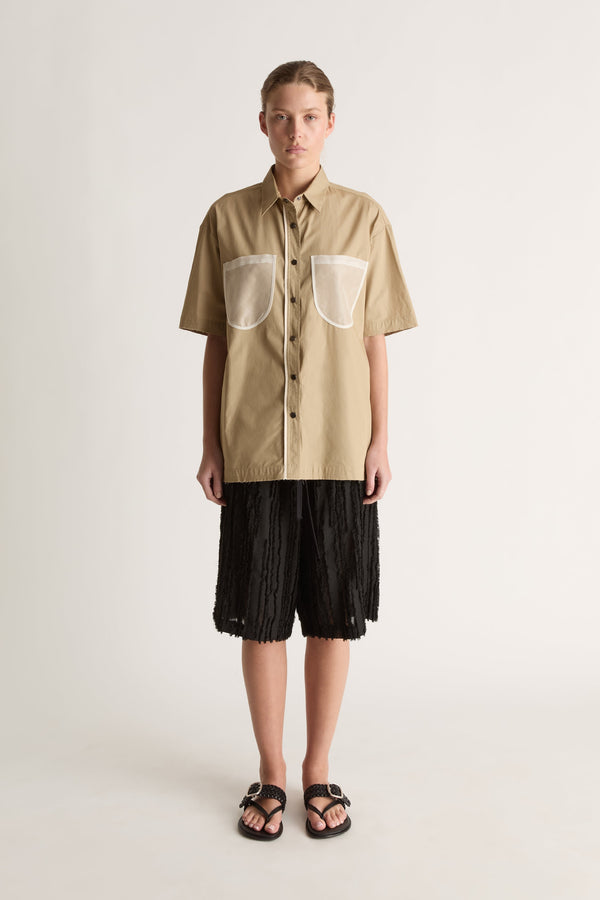 Front view of a camel short-sleeve button-up shirt with two sheer white chest pockets and white placket trim.