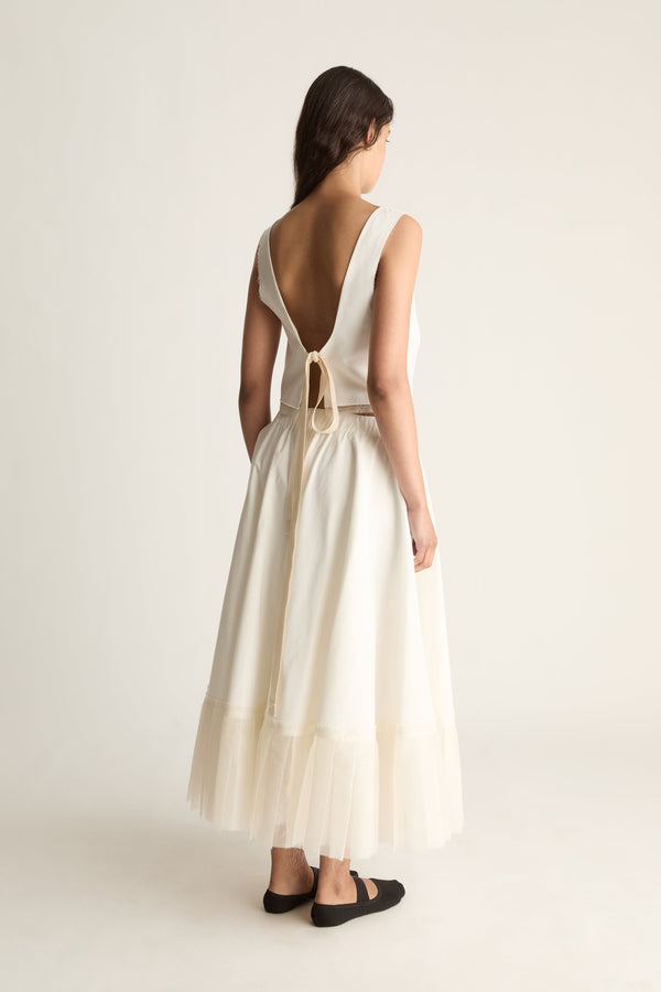 Back view of a full cream maxi skirt with an elasticated waist and a sheer layered hem.
