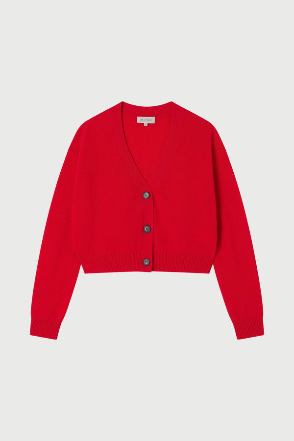 Red cardigan with buttons on a light gray background