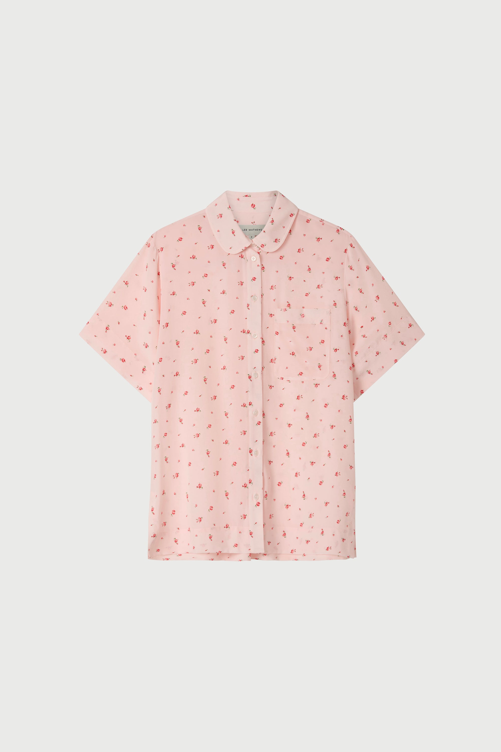 Pink floral short sleeve shirt on a white background