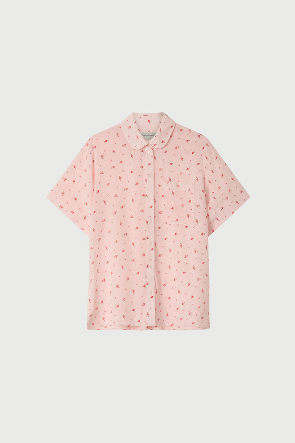 Pink floral short sleeve shirt on a white background