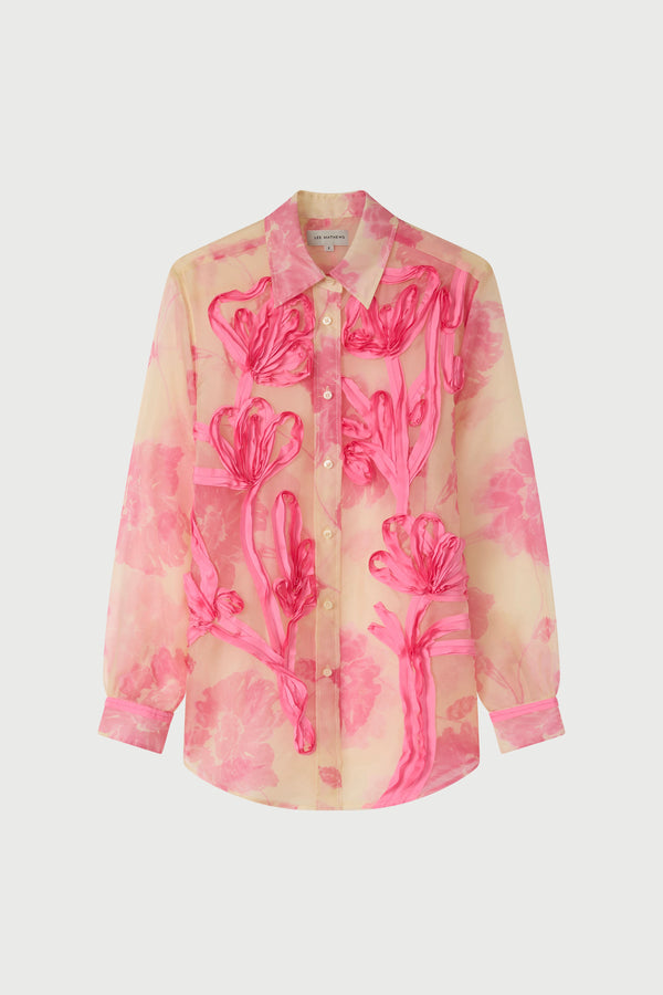 Pink floral patterned shirt on a white background