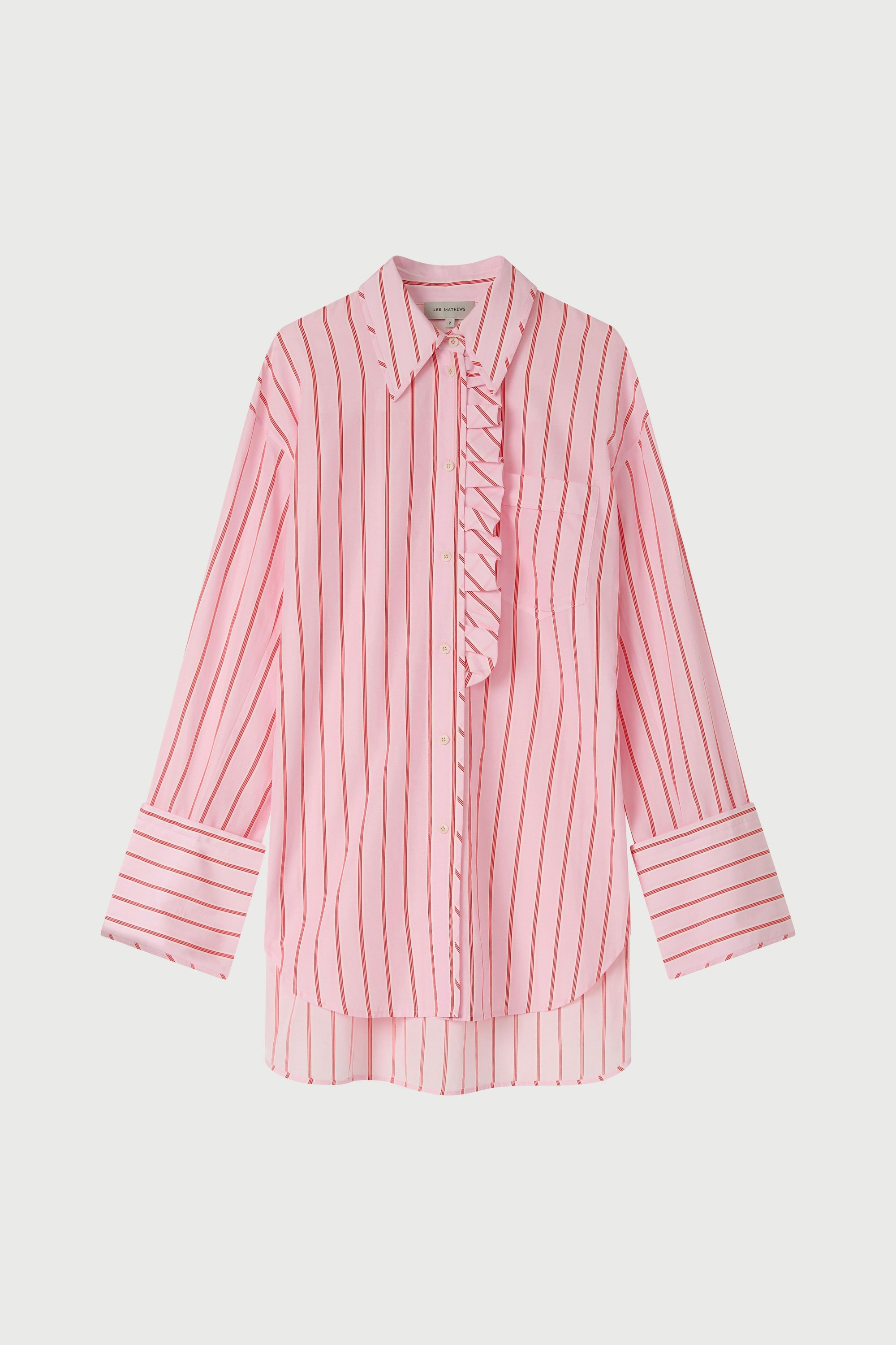 Woman wearing a pink striped shirt and pink floral pants on a white background