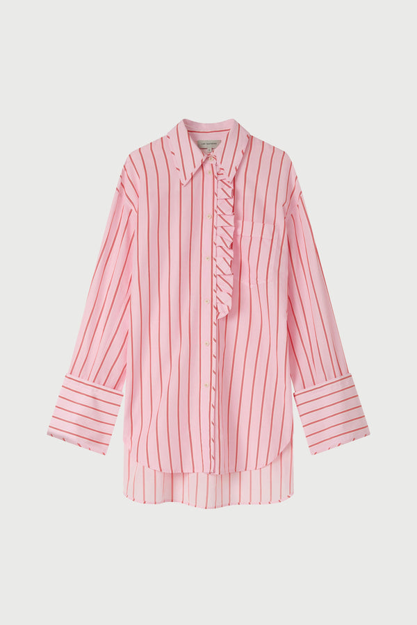 Woman wearing a pink striped shirt and pink floral pants on a white background