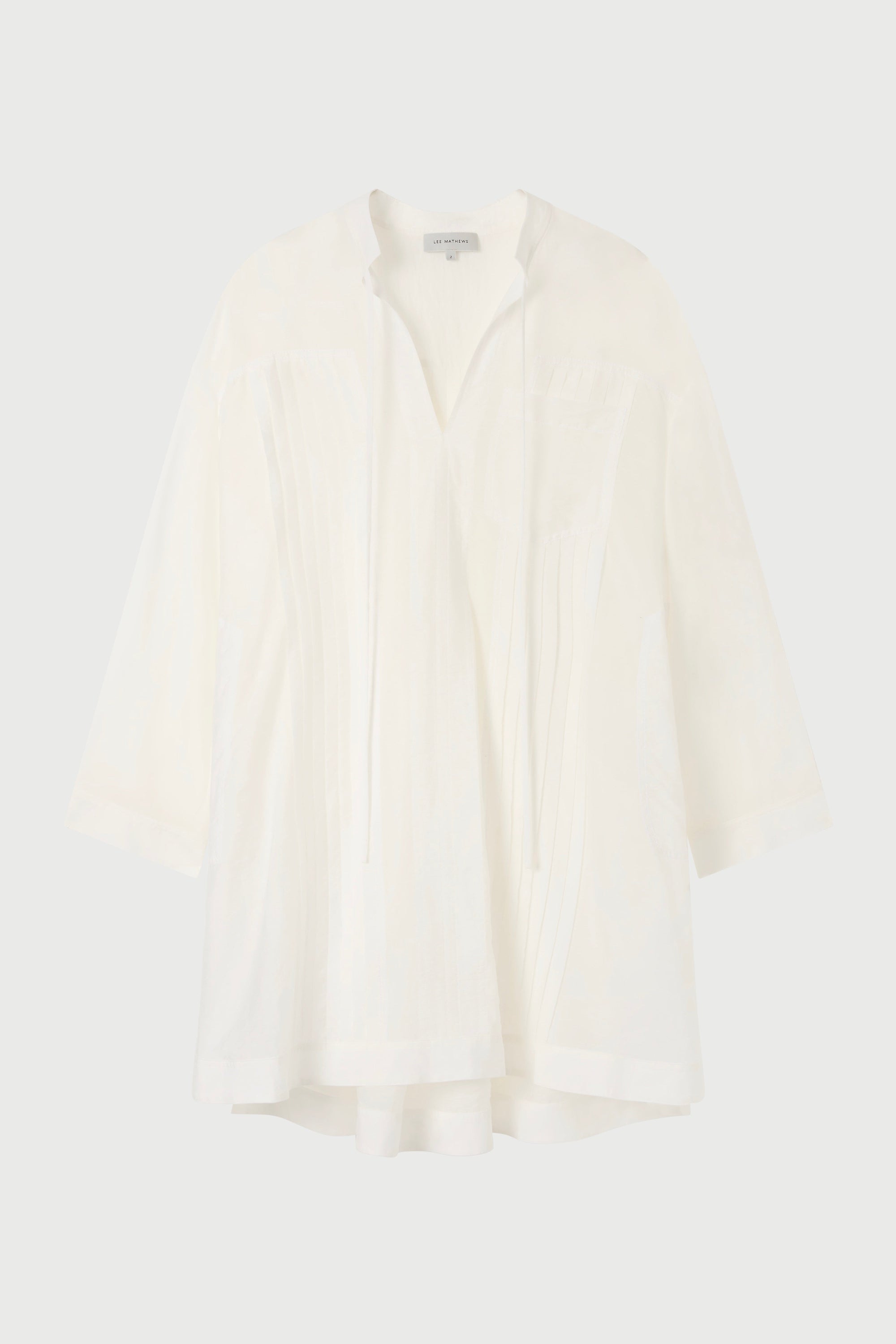 A white tunic against a plain background