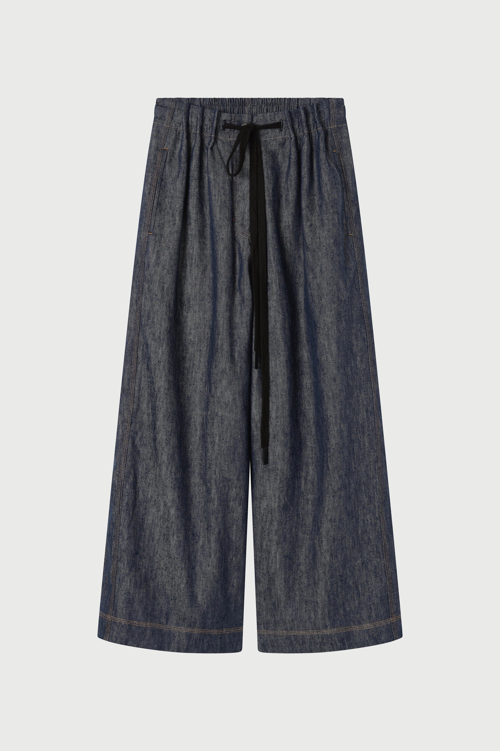 Dark blue denim pants with a drawstring on a light gray background