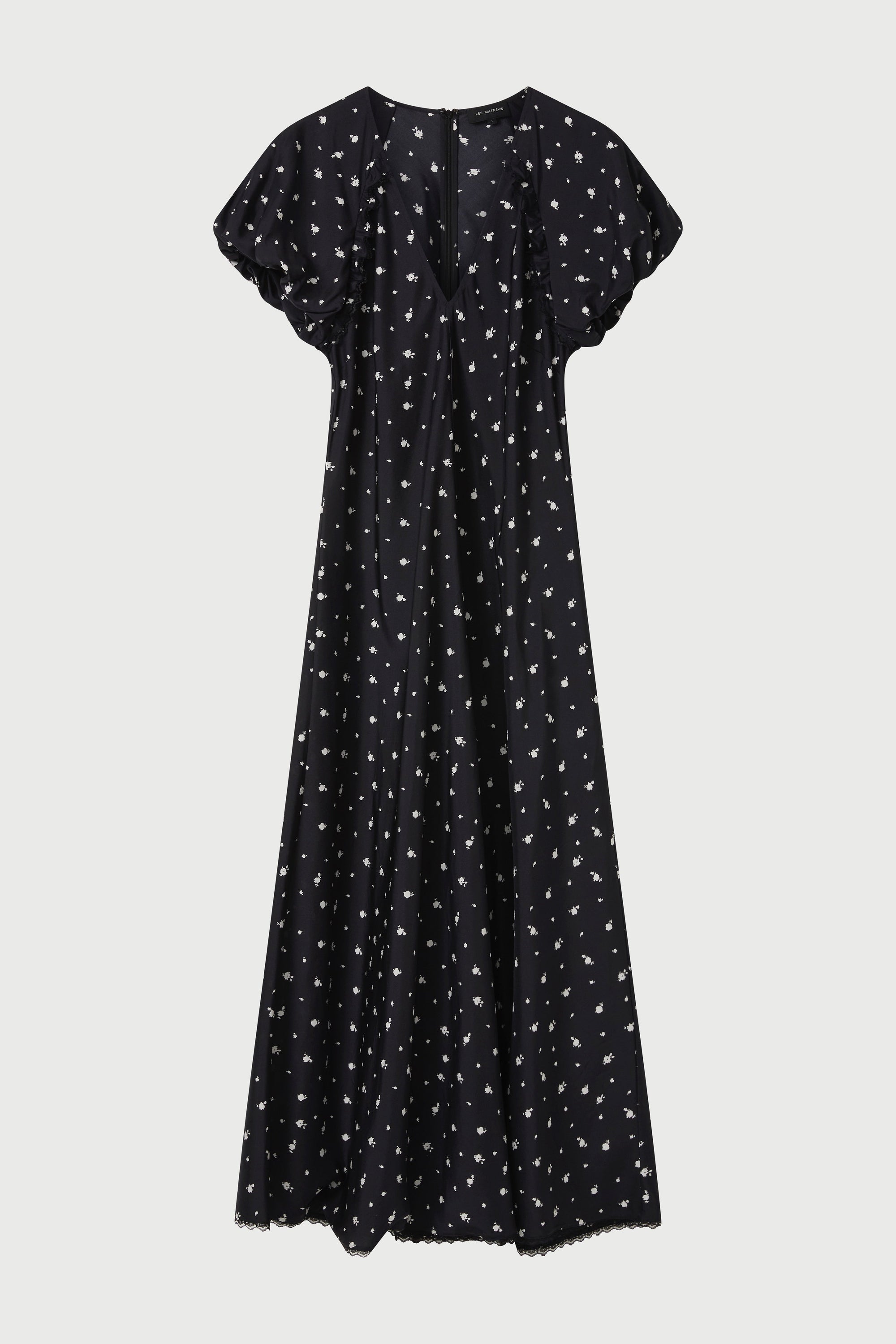 Black dress with white pattern on a light gray background