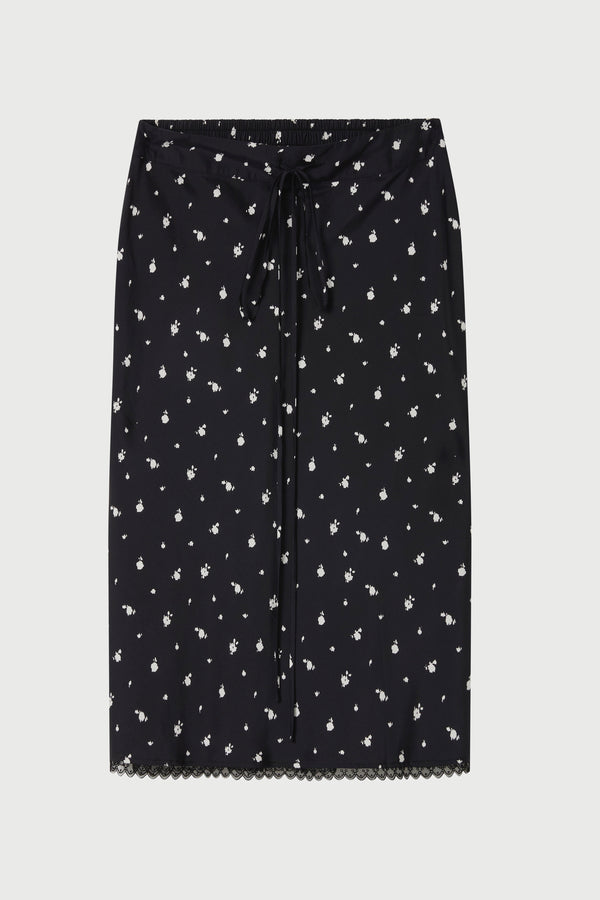 Black skirt with white floral pattern on a light gray background